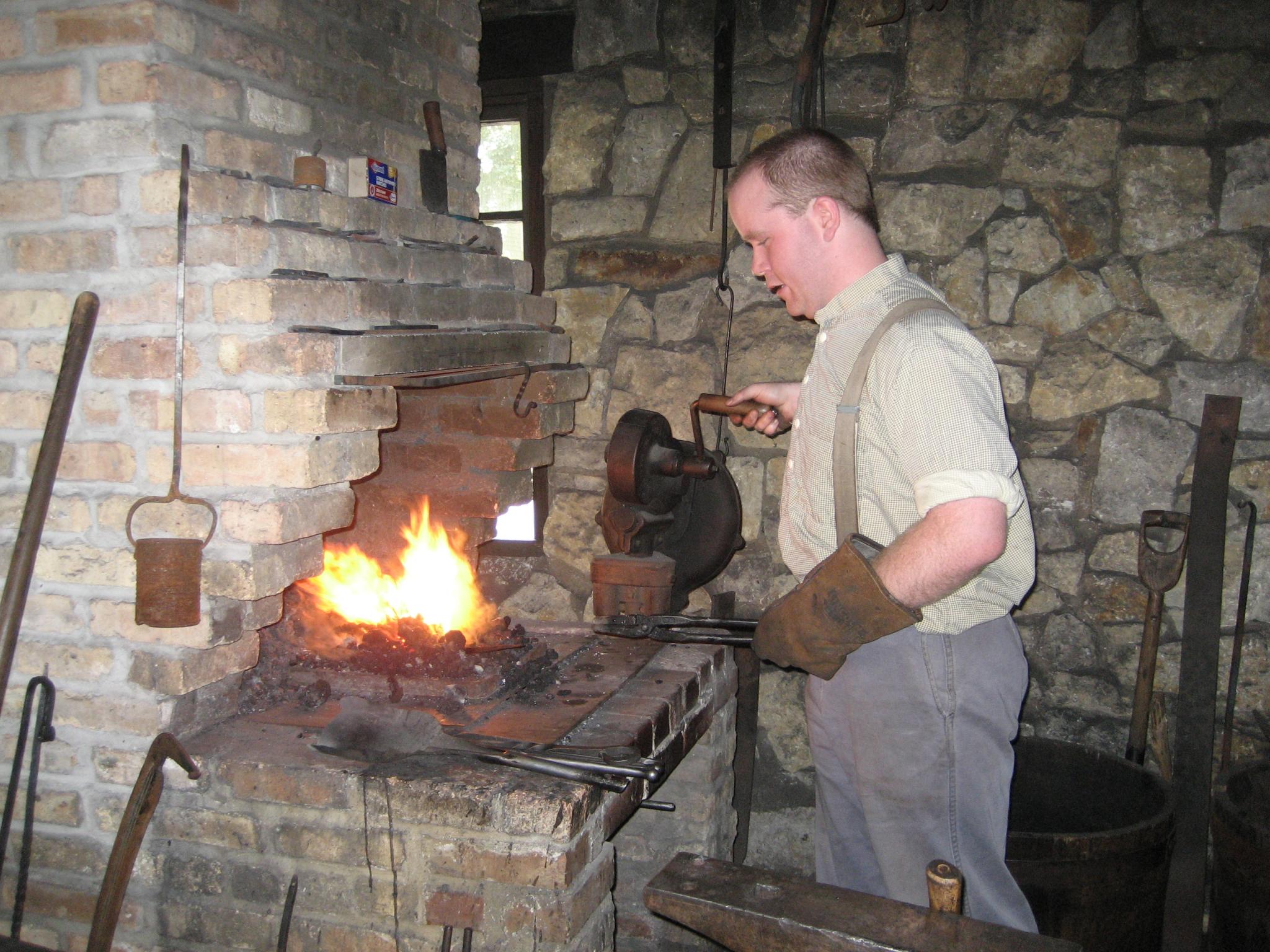 Blacksmith using forge in Blacksmith Shop