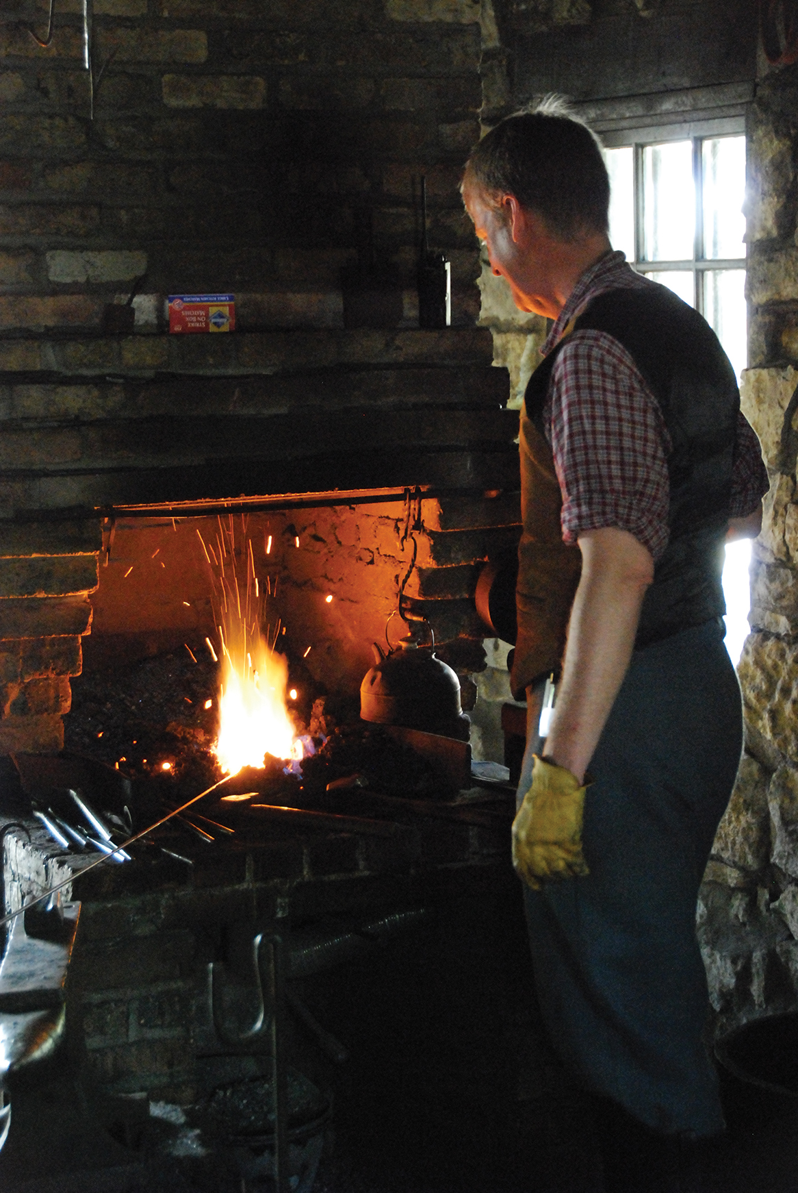 Blacksmith working at forge in Blacksmith Shop